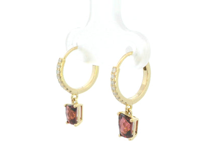 18K yellow gold hoop earrings with natural garnet drops and diamond accents, elegant fine jewelry by Emirates Diamonds.