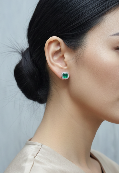 18K white gold emerald and diamond halo stud earrings with square-cut emeralds and brilliant diamond accents by Emirates Diamonds