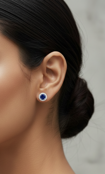 18K white gold blue sapphire and diamond halo stud earrings with round sapphires, 1.40 carat sapphires and 0.20 carat diamonds by Emirates Diamonds