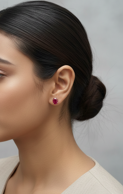 18K yellow gold ruby stud earrings featuring oval-cut natural rubies totaling 5.19 carats by Emirates Diamonds.