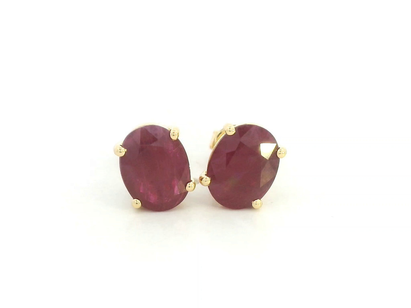 18K yellow gold ruby stud earrings featuring oval-cut natural rubies totaling 5.19 carats by Emirates Diamonds.