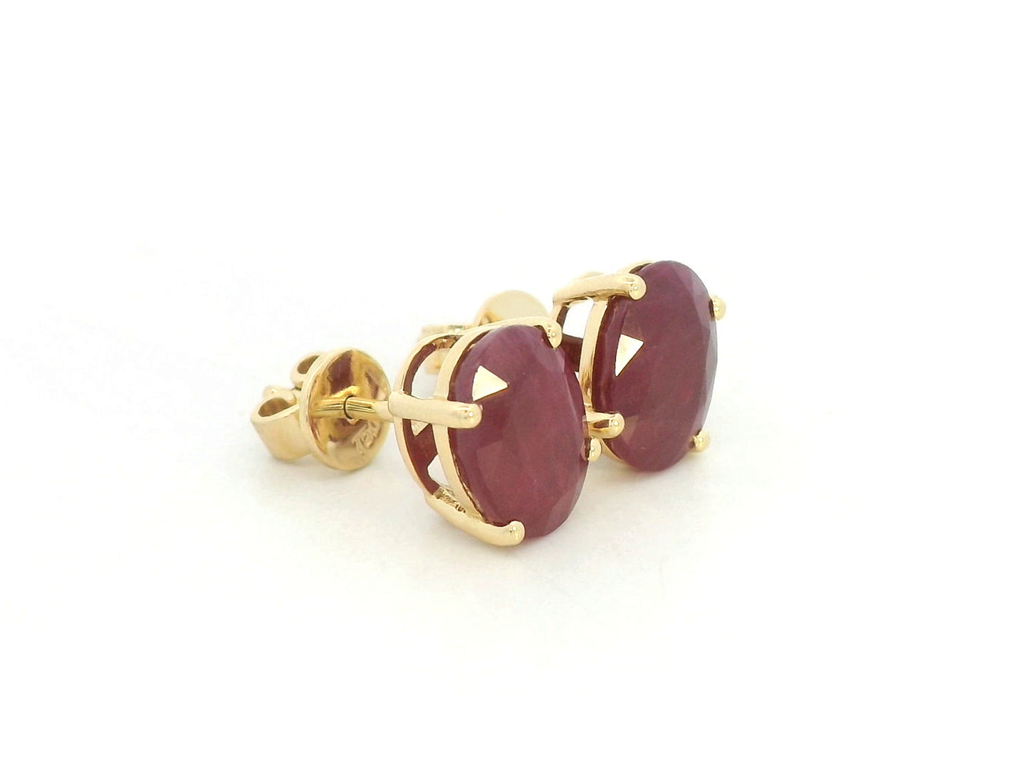 18K yellow gold ruby stud earrings featuring oval-cut natural rubies totaling 5.19 carats by Emirates Diamonds.