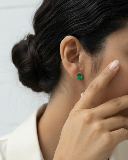 Oval-cut emerald stud earrings in 18K white gold with 3.87 carat total emerald weight by Emirates Diamonds