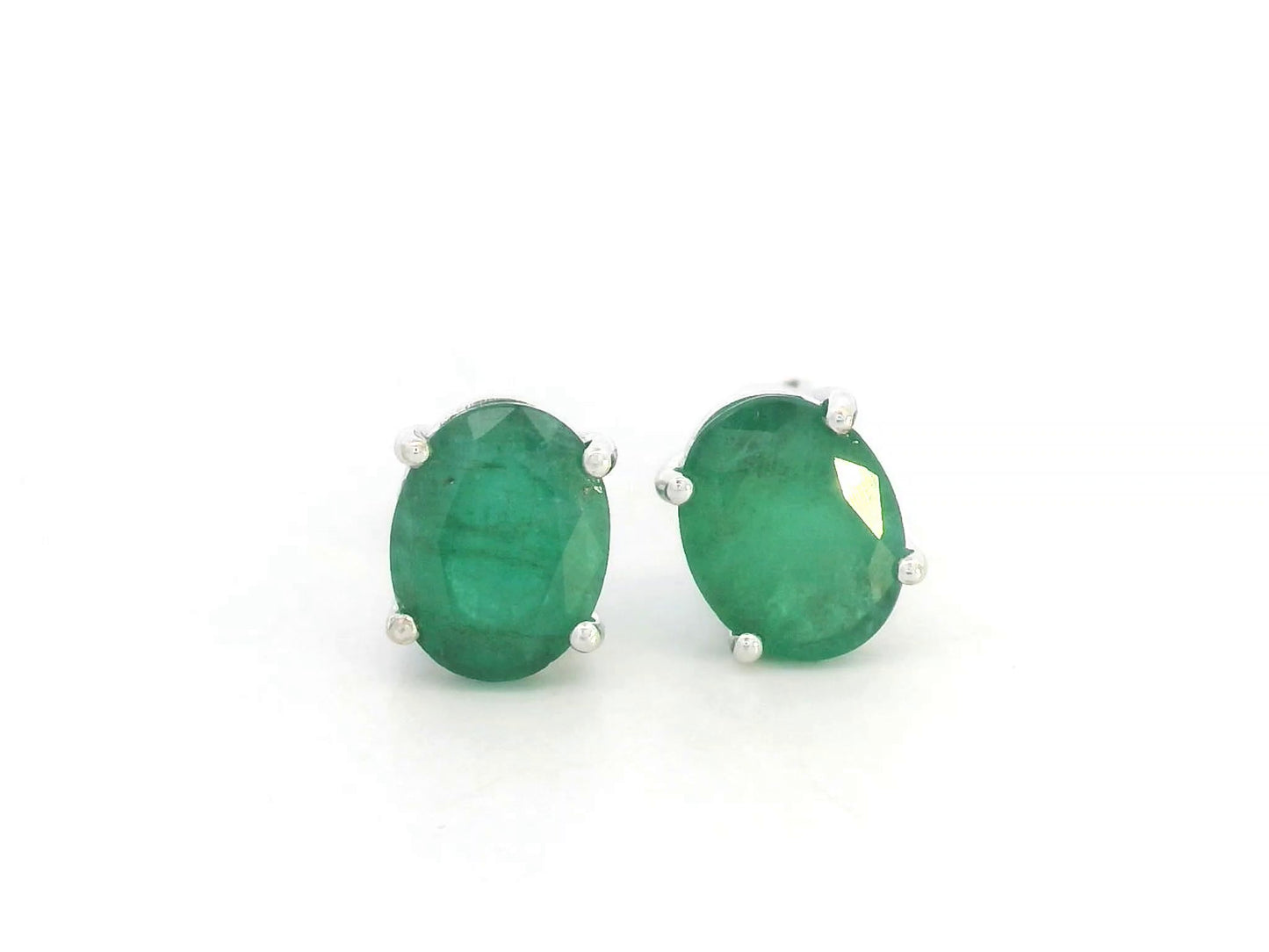 Oval-cut emerald stud earrings in 18K white gold with 3.87 carat total emerald weight by Emirates Diamonds