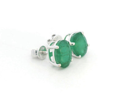 Oval-cut emerald stud earrings in 18K white gold with 3.87 carat total emerald weight by Emirates Diamonds