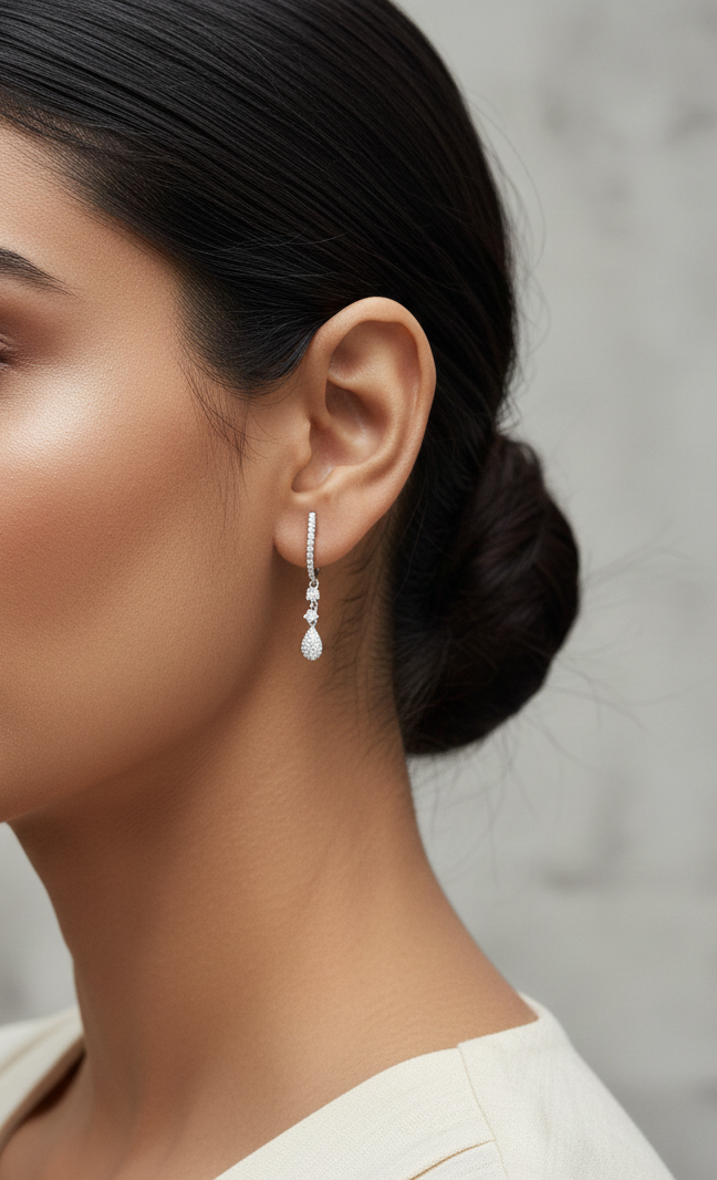 18K white gold diamond drop earrings with pavé-set hoop design and dangling teardrop diamonds by Emirates Diamonds