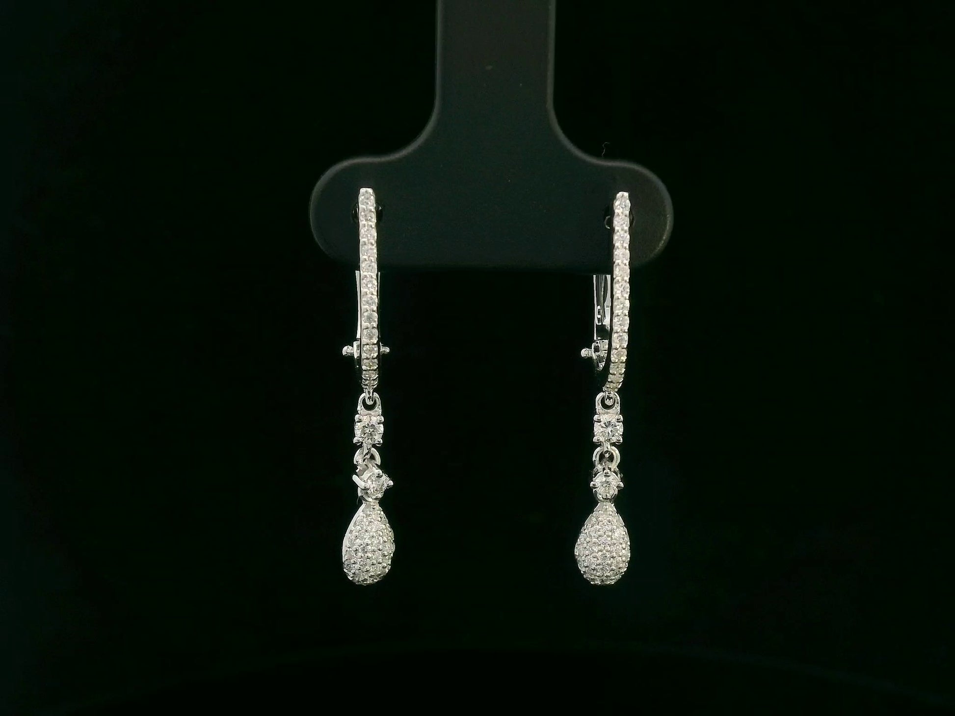 18K white gold diamond drop earrings with pavé-set hoop design and dangling teardrop diamonds by Emirates Diamonds
