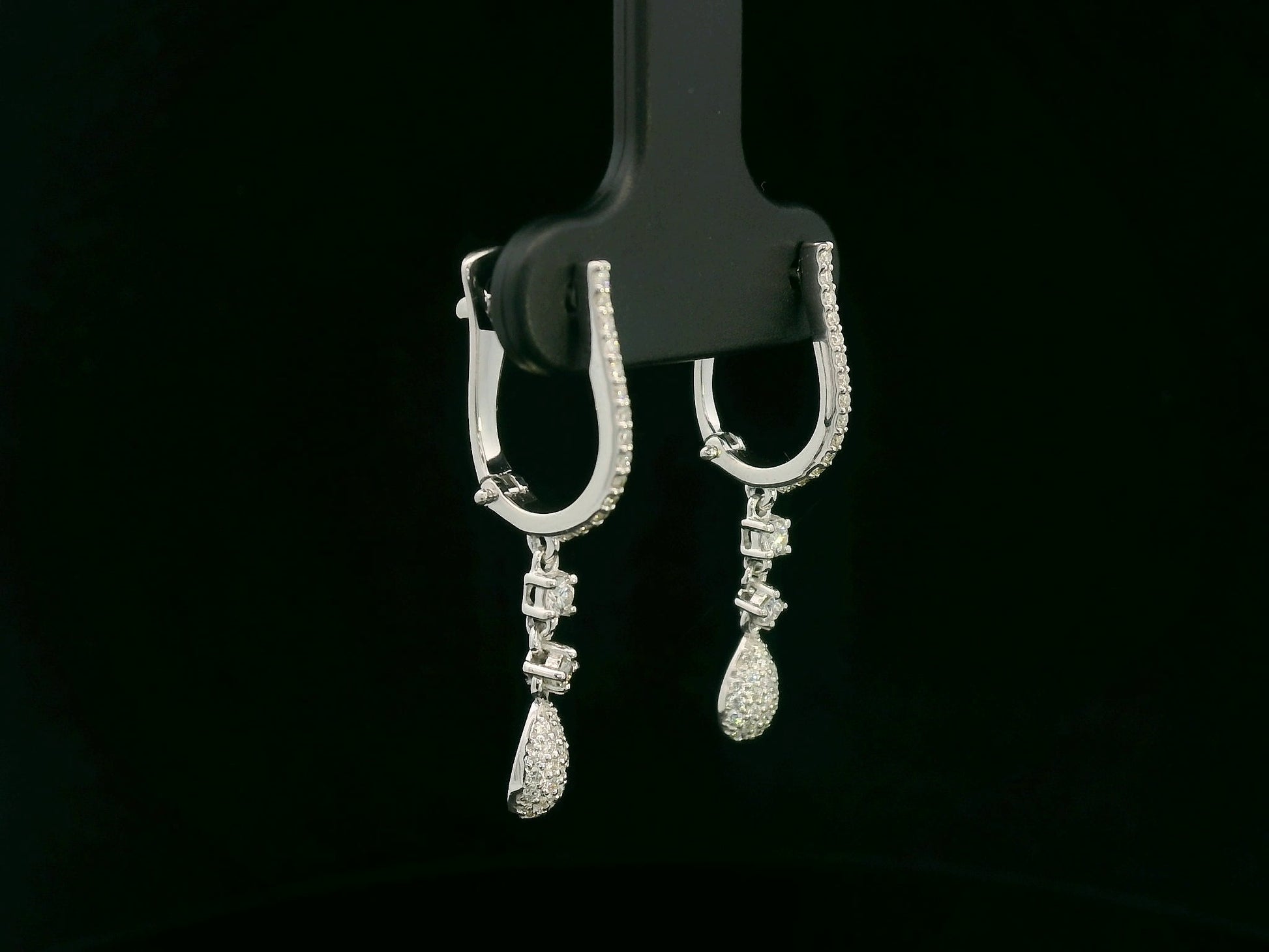18K white gold diamond drop earrings with pavé-set hoop design and dangling teardrop diamonds by Emirates Diamonds