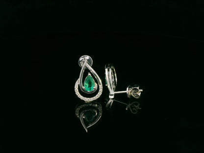 Emerald and diamond stud earrings in 18K white gold with pear-cut emeralds and pavé diamond accents by Emirates Diamonds