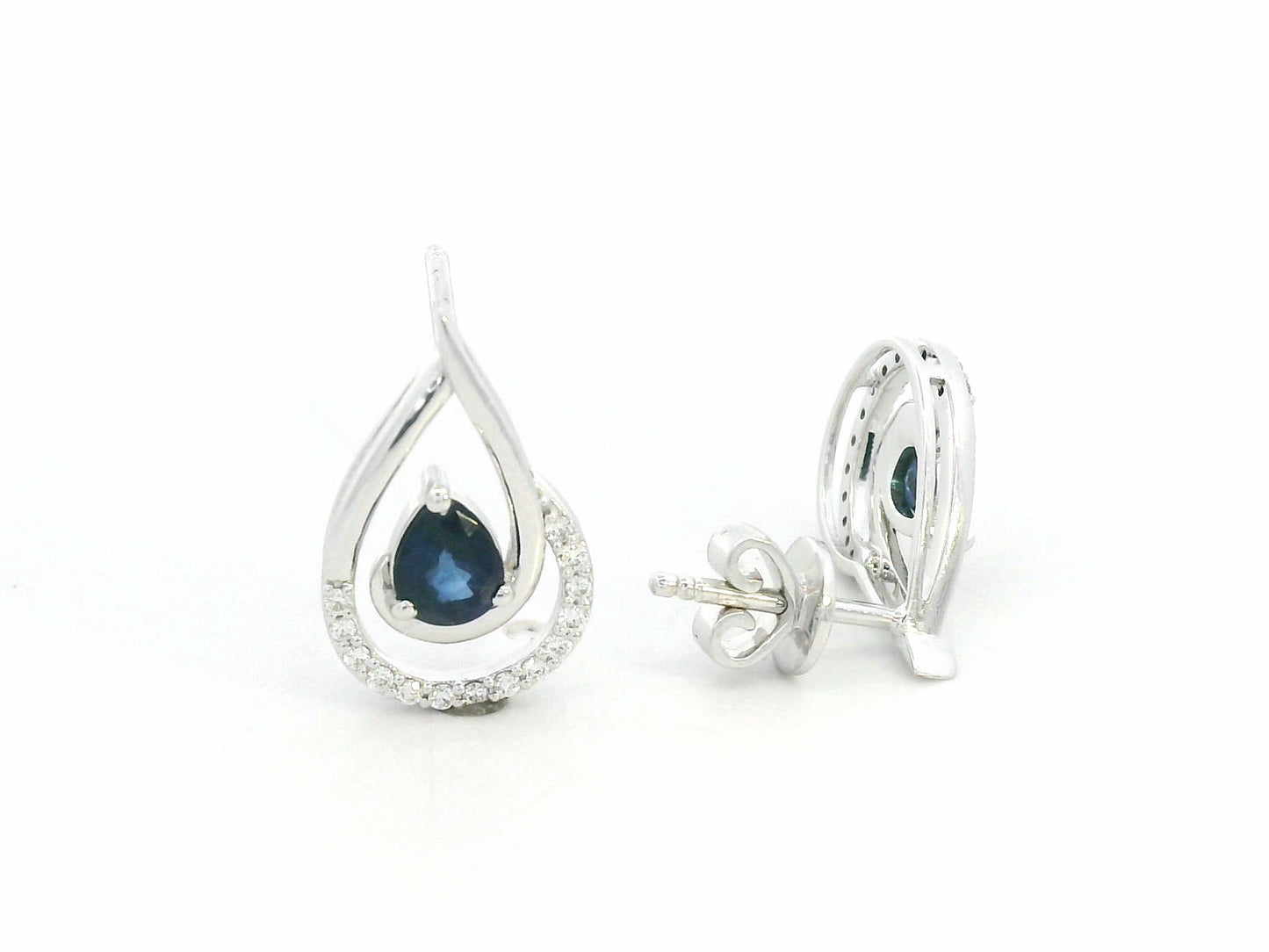 Blue sapphire and diamond stud earrings in 18K white gold with pear-cut sapphires and pavé diamond accents by Emirates Diamonds