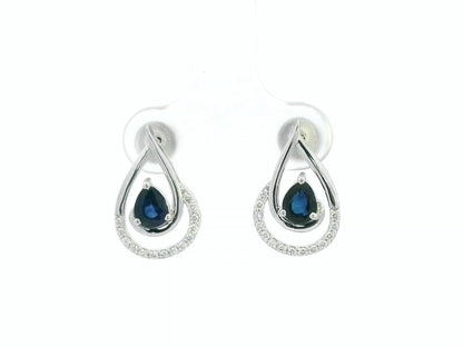Blue sapphire and diamond stud earrings in 18K white gold with pear-cut sapphires and pavé diamond accents by Emirates Diamonds