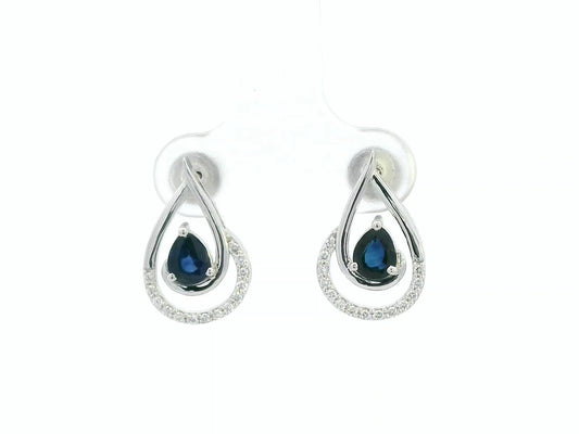 Blue sapphire and diamond stud earrings in 18K white gold with pear-cut sapphires and pavé diamond accents by Emirates Diamonds