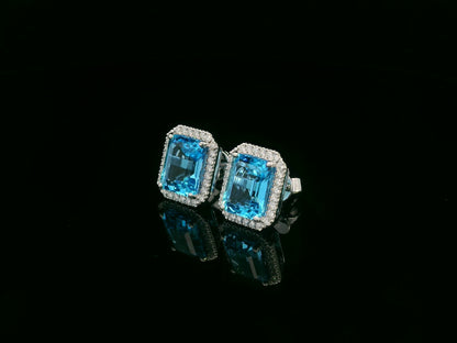 Swiss blue topaz and diamond stud earrings in 18K white gold with emerald-cut topaz and diamond halo by Emirates Diamonds
