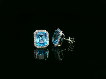 Swiss blue topaz and diamond stud earrings in 18K white gold with emerald-cut topaz and diamond halo by Emirates Diamonds