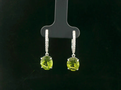 Peridot and diamond drop hoop earrings in 18K white gold with oval-cut peridots totaling 4.86 carats by Emirates Diamonds