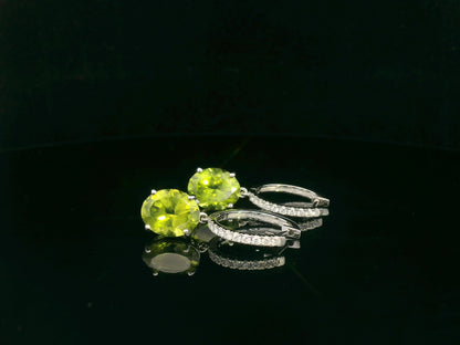 Peridot and diamond drop hoop earrings in 18K white gold with oval-cut peridots totaling 4.86 carats by Emirates Diamonds