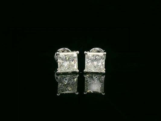 Princess cut diamond solitaire stud earrings in 18K white gold featuring 2.02 carats total GIA certified VS2 F color diamonds by Emirates Diamonds