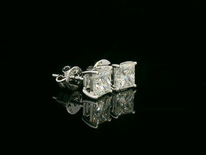 Princess cut diamond solitaire stud earrings in 18K white gold featuring 2.02 carats total GIA certified VS2 F color diamonds by Emirates Diamonds