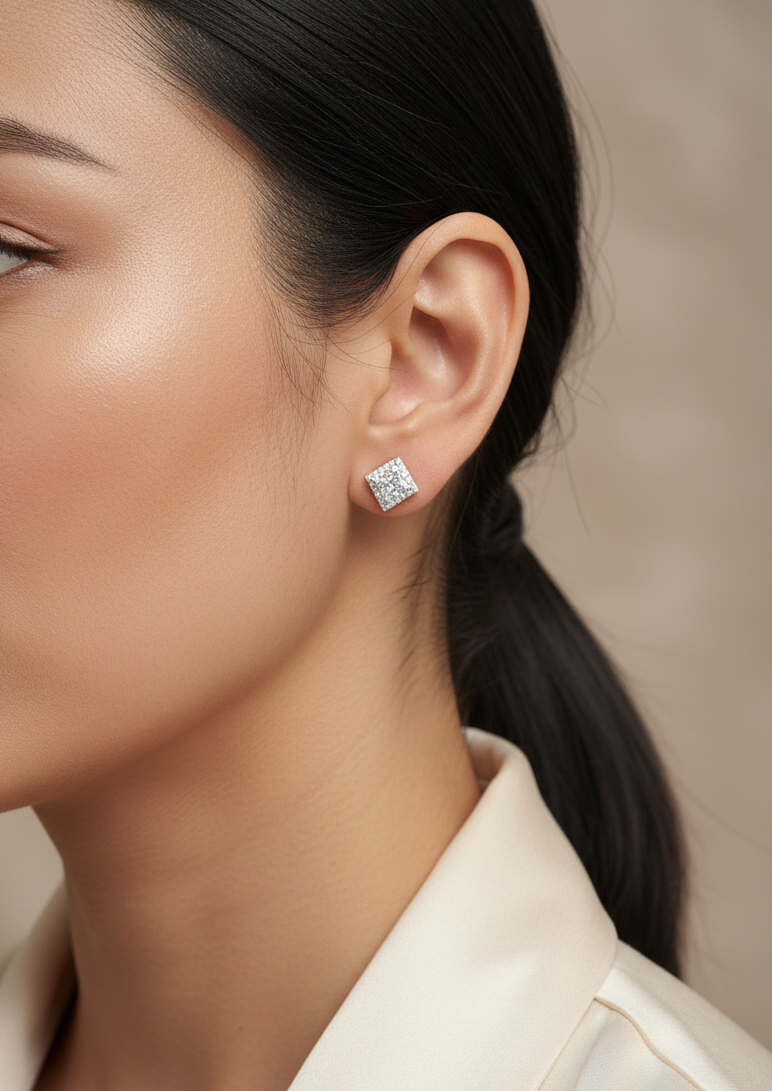 Princess cut diamond halo stud earrings in 18K white gold featuring GIA certified 1.01 carat E color VS2 diamonds with halo accents by Emirates Diamonds