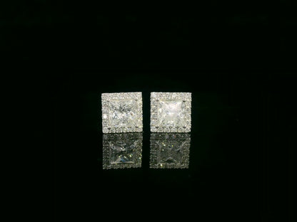 Princess cut diamond halo stud earrings in 18K white gold featuring GIA certified 1.01 carat E color VS2 diamonds with halo accents by Emirates Diamonds
