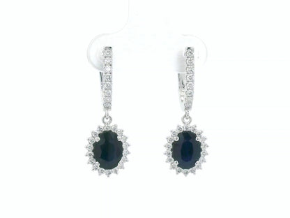 18K white gold sapphire and diamond drop earrings with oval sapphire halos by Emirates Diamonds