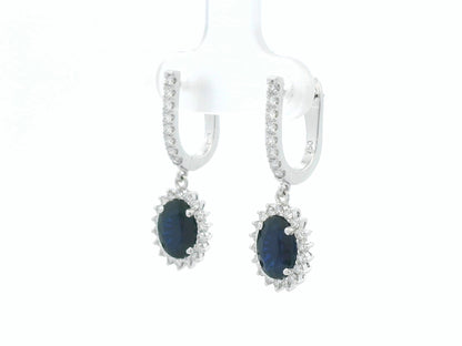18K white gold sapphire and diamond drop earrings with oval sapphire halos by Emirates Diamonds