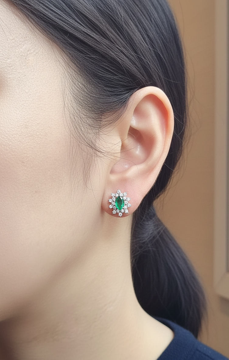 18K white gold emerald and diamond stud earrings with oval emerald center by Emirates Diamonds