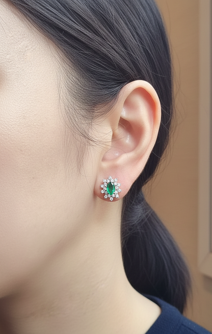 18K white gold emerald and diamond stud earrings with oval emerald center by Emirates Diamonds
