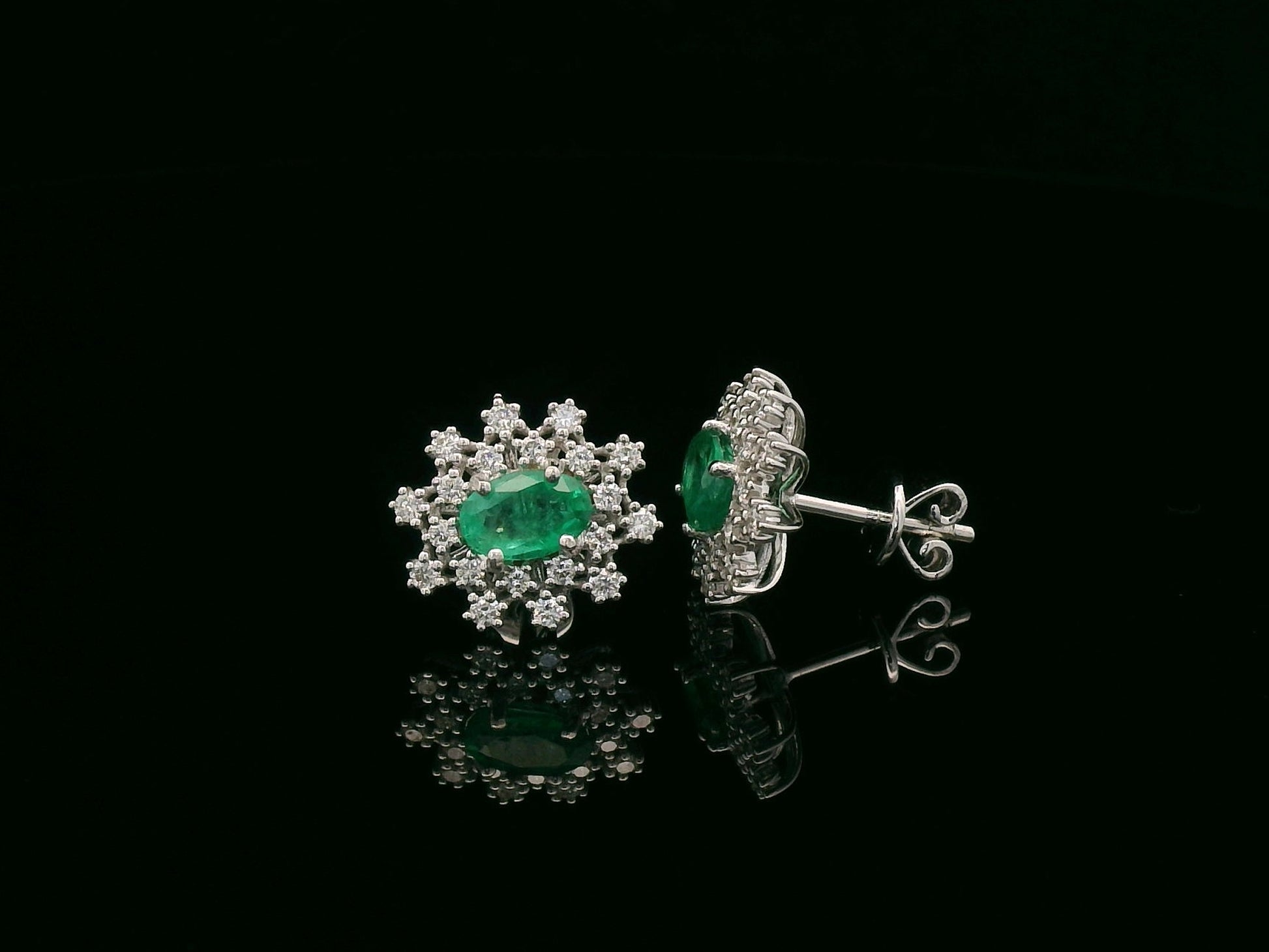 18K white gold emerald and diamond stud earrings with oval emerald center by Emirates Diamonds