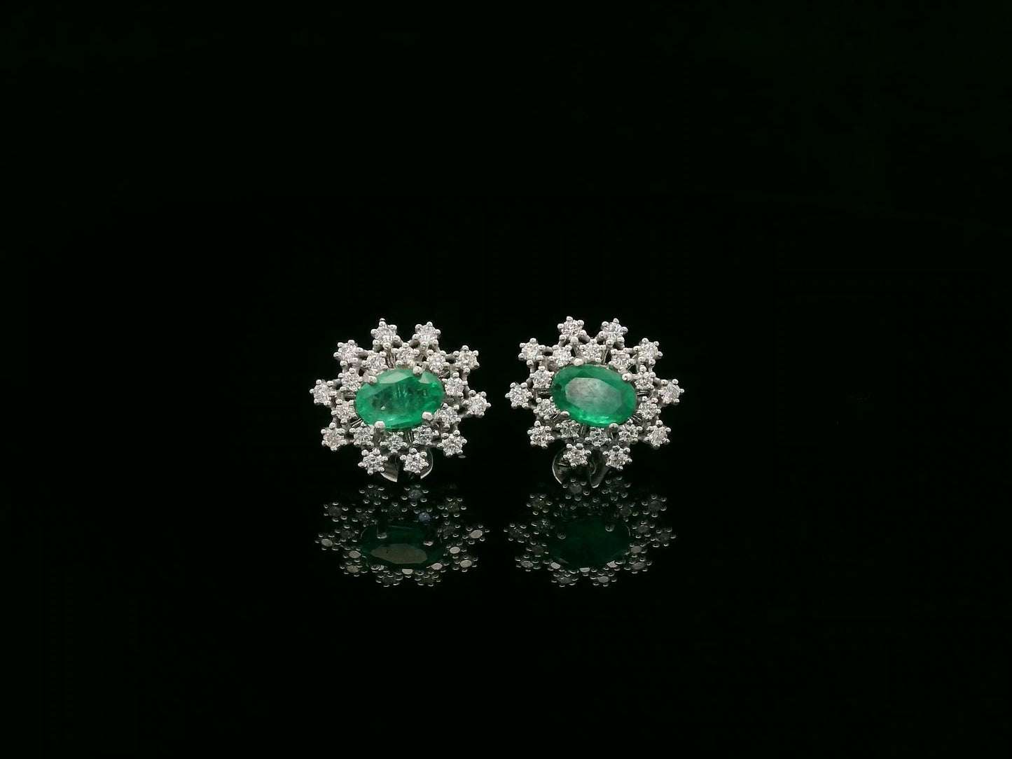 18K white gold emerald and diamond stud earrings with oval emerald center by Emirates Diamonds