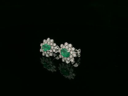 18K white gold emerald and diamond stud earrings with oval emerald center by Emirates Diamonds