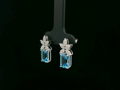 18K white gold Swiss blue topaz and diamond stud earrings with  diamond floral design – Emirates Diamonds