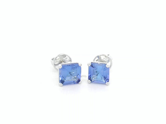 Square emerald-cut tanzanite solitaire stud earrings in 18K white gold by Emirates Diamonds.