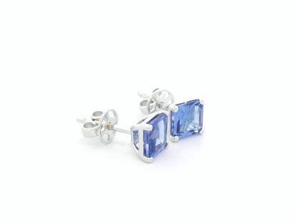 Square emerald-cut tanzanite solitaire stud earrings in 18K white gold by Emirates Diamonds.
