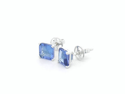 Square emerald-cut tanzanite solitaire stud earrings in 18K white gold by Emirates Diamonds.