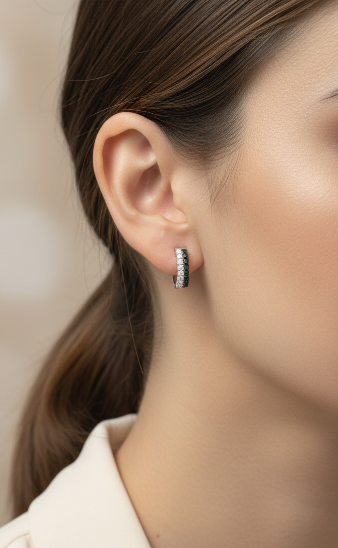 18K white gold hoop earrings with white and black pavé-set diamonds, modern luxury design by Emirates Diamonds.