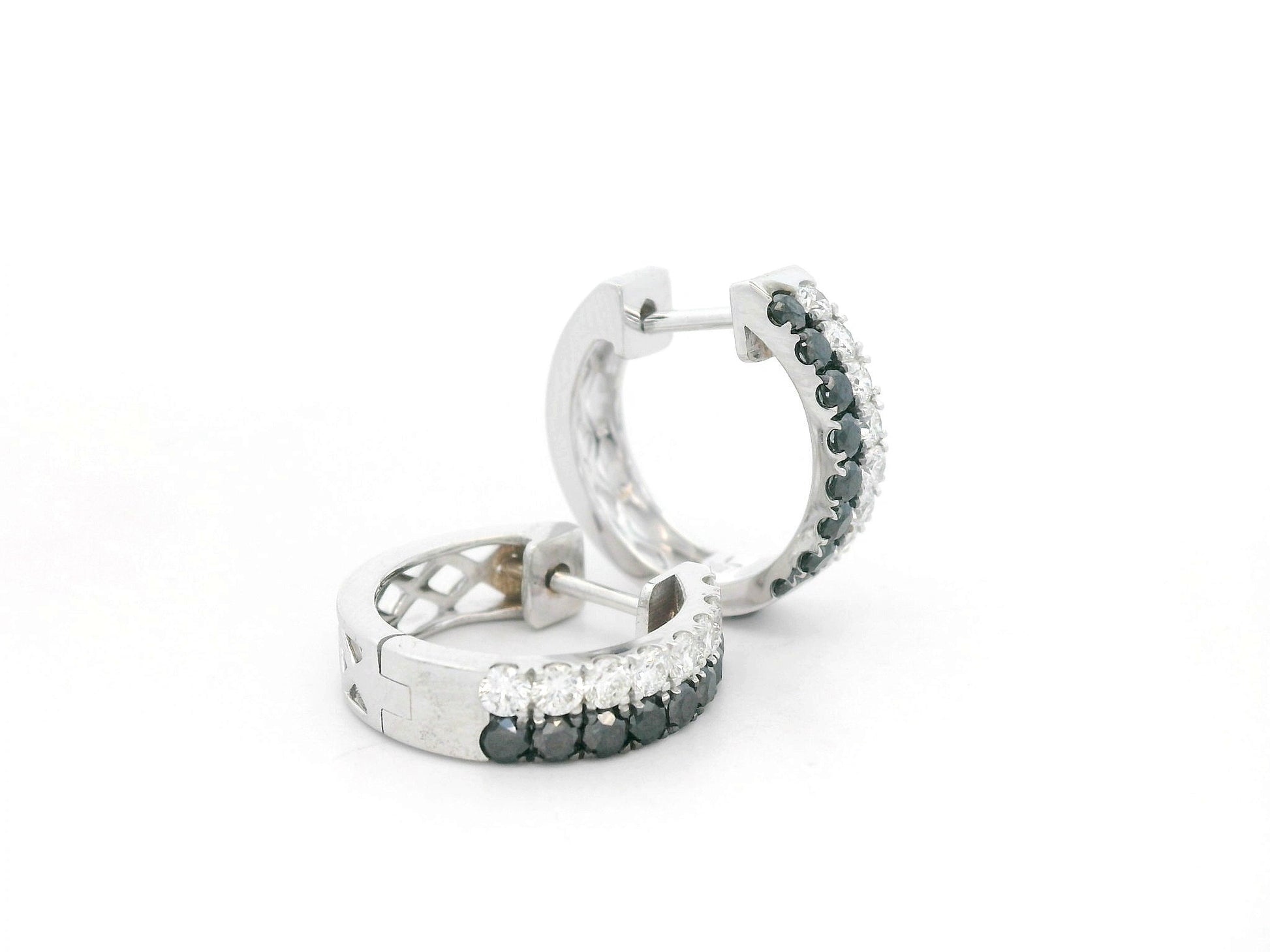 18K white gold hoop earrings with white and black pavé-set diamonds, modern luxury design by Emirates Diamonds.