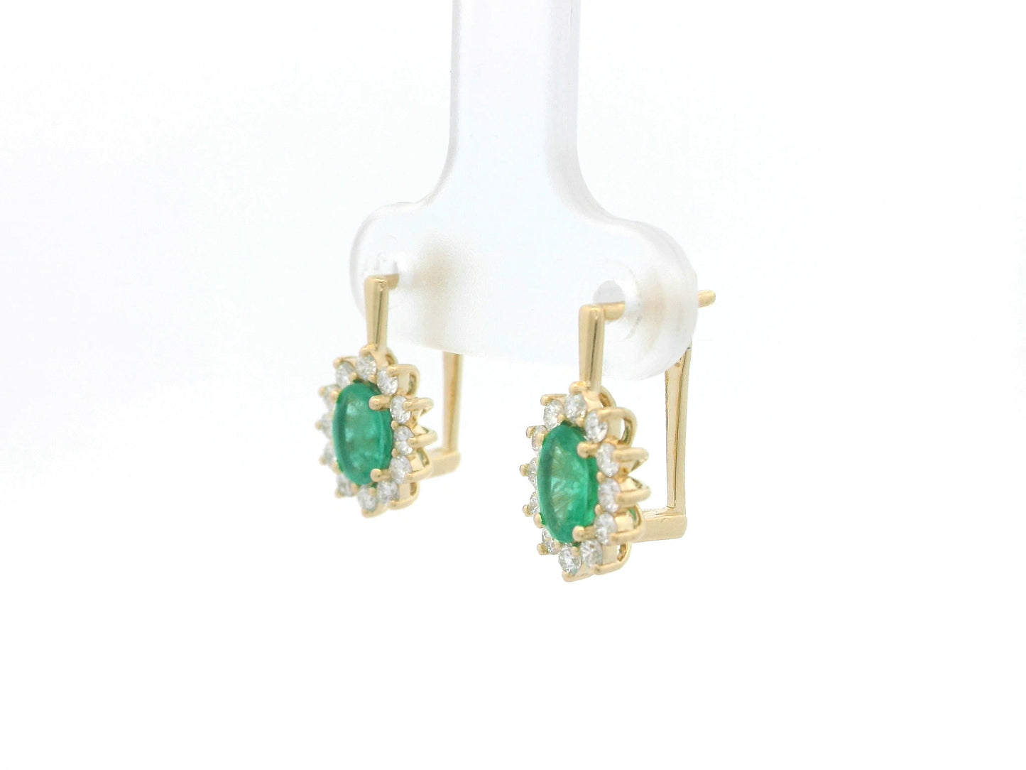 18K yellow gold emerald and diamond halo earrings featuring oval-cut emeralds surrounded by brilliant diamonds by Emirates Diamonds.