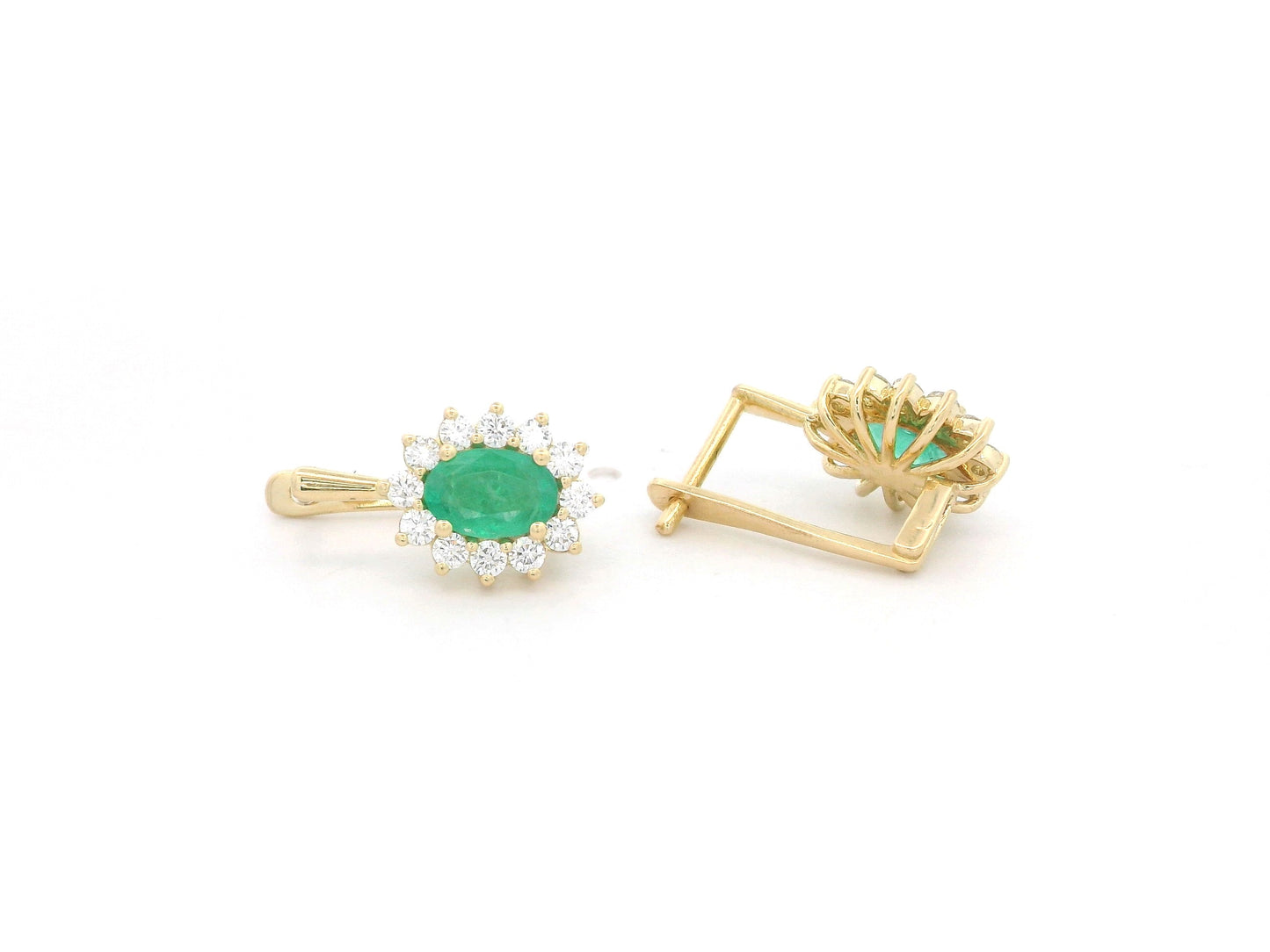 18K yellow gold emerald and diamond halo earrings featuring oval-cut emeralds surrounded by brilliant diamonds by Emirates Diamonds.
