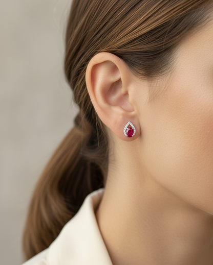 18K white gold ruby and diamond stud earrings featuring oval-cut rubies with diamond accents by Emirates Diamonds.
