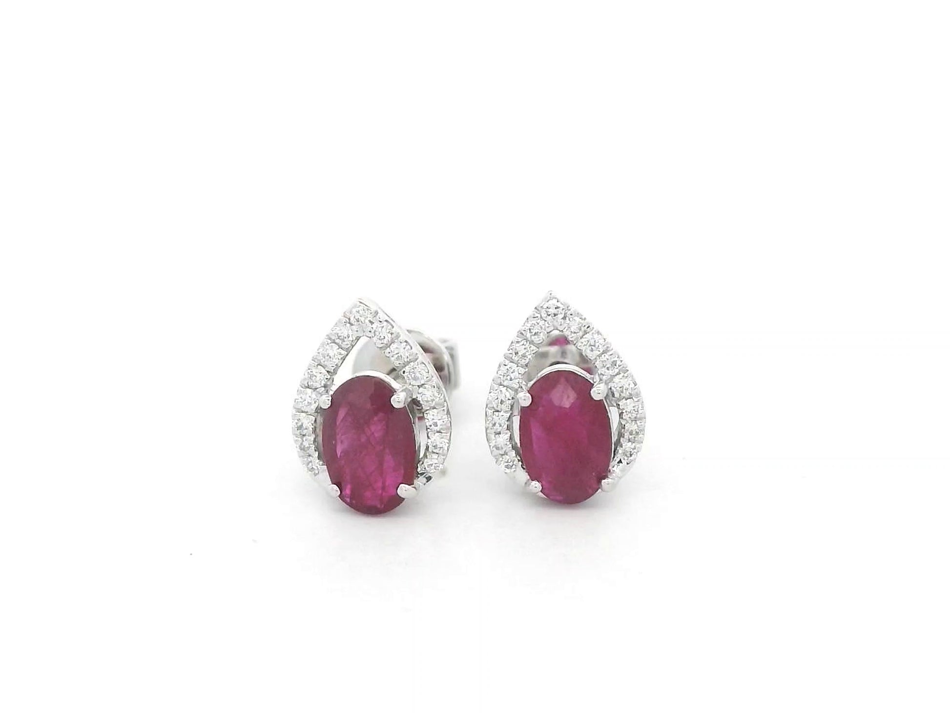 18K white gold ruby and diamond stud earrings featuring oval-cut rubies with diamond accents by Emirates Diamonds.