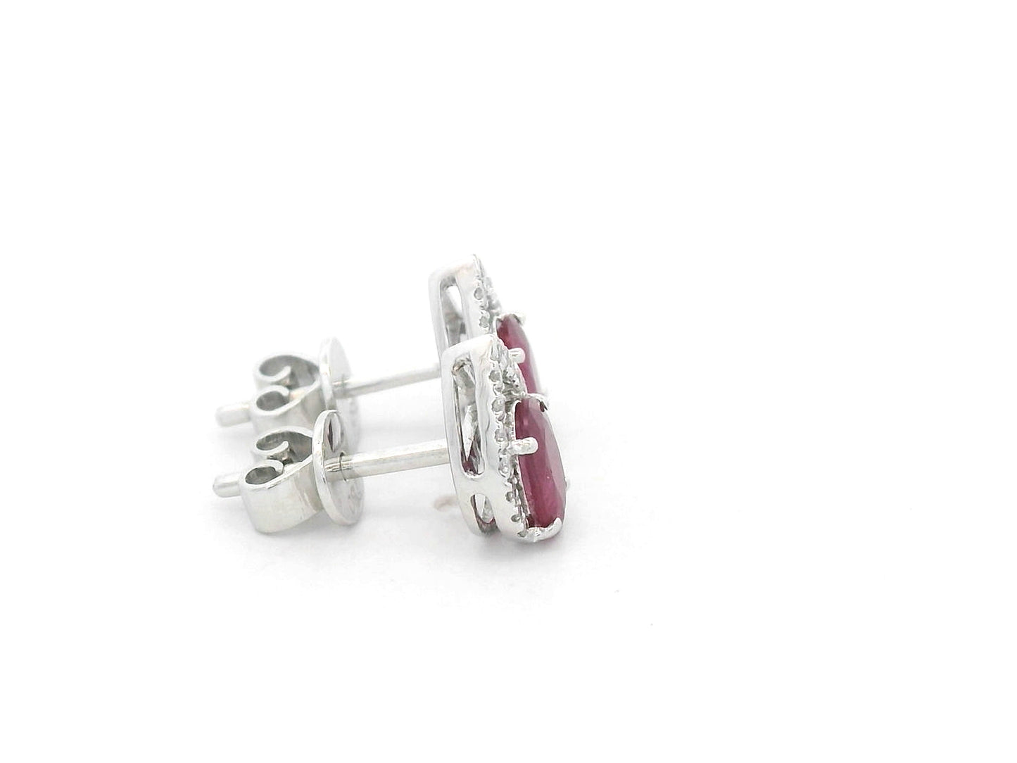 18K white gold ruby and diamond stud earrings featuring oval-cut rubies with diamond accents by Emirates Diamonds.