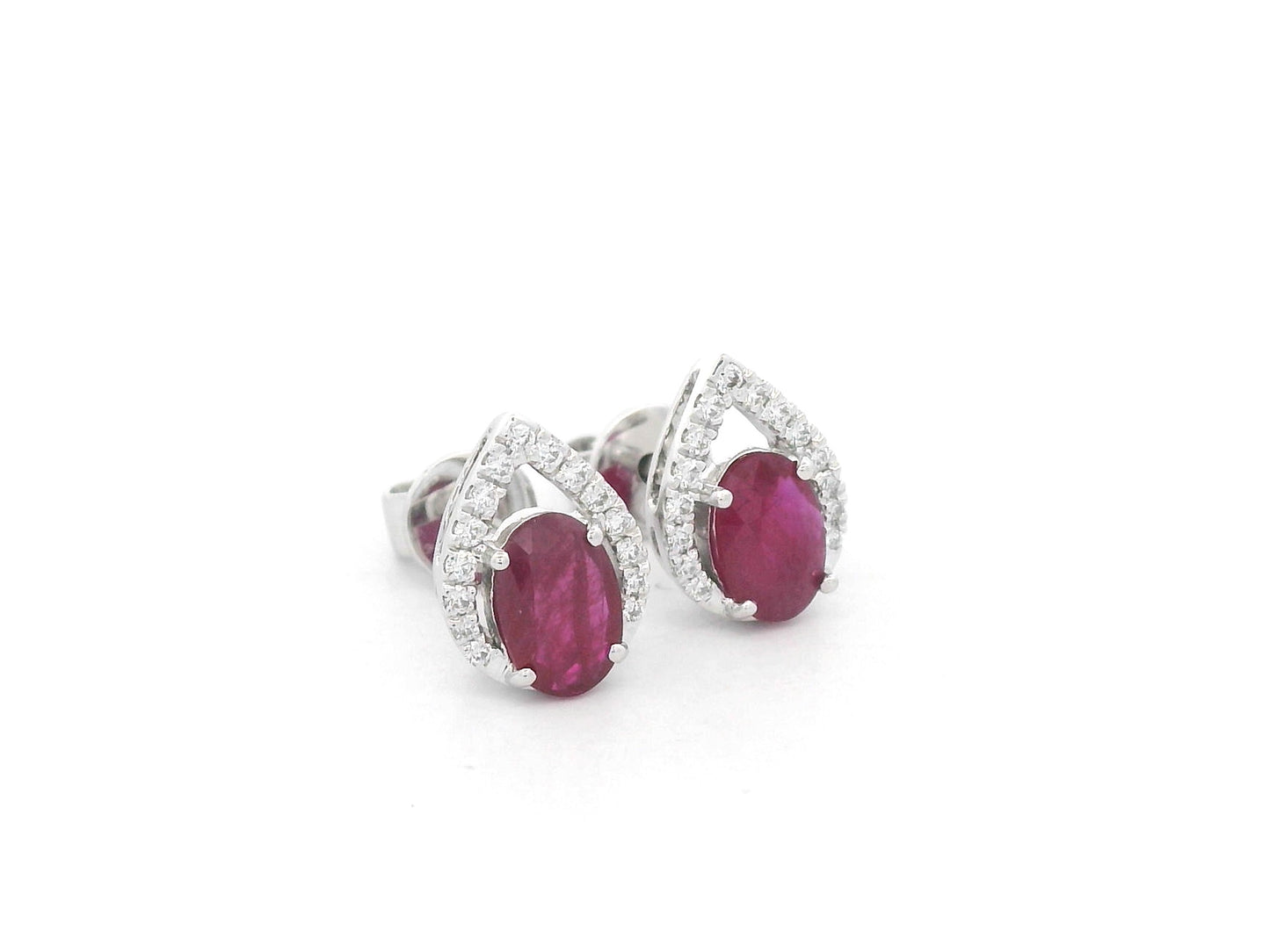 18K white gold ruby and diamond stud earrings featuring oval-cut rubies with diamond accents by Emirates Diamonds.