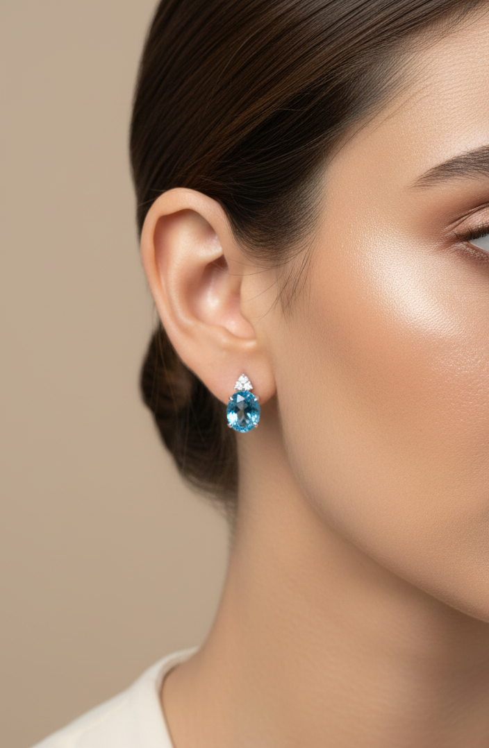 18K white gold stud earrings with oval Swiss Blue Topaz and  diamond accents