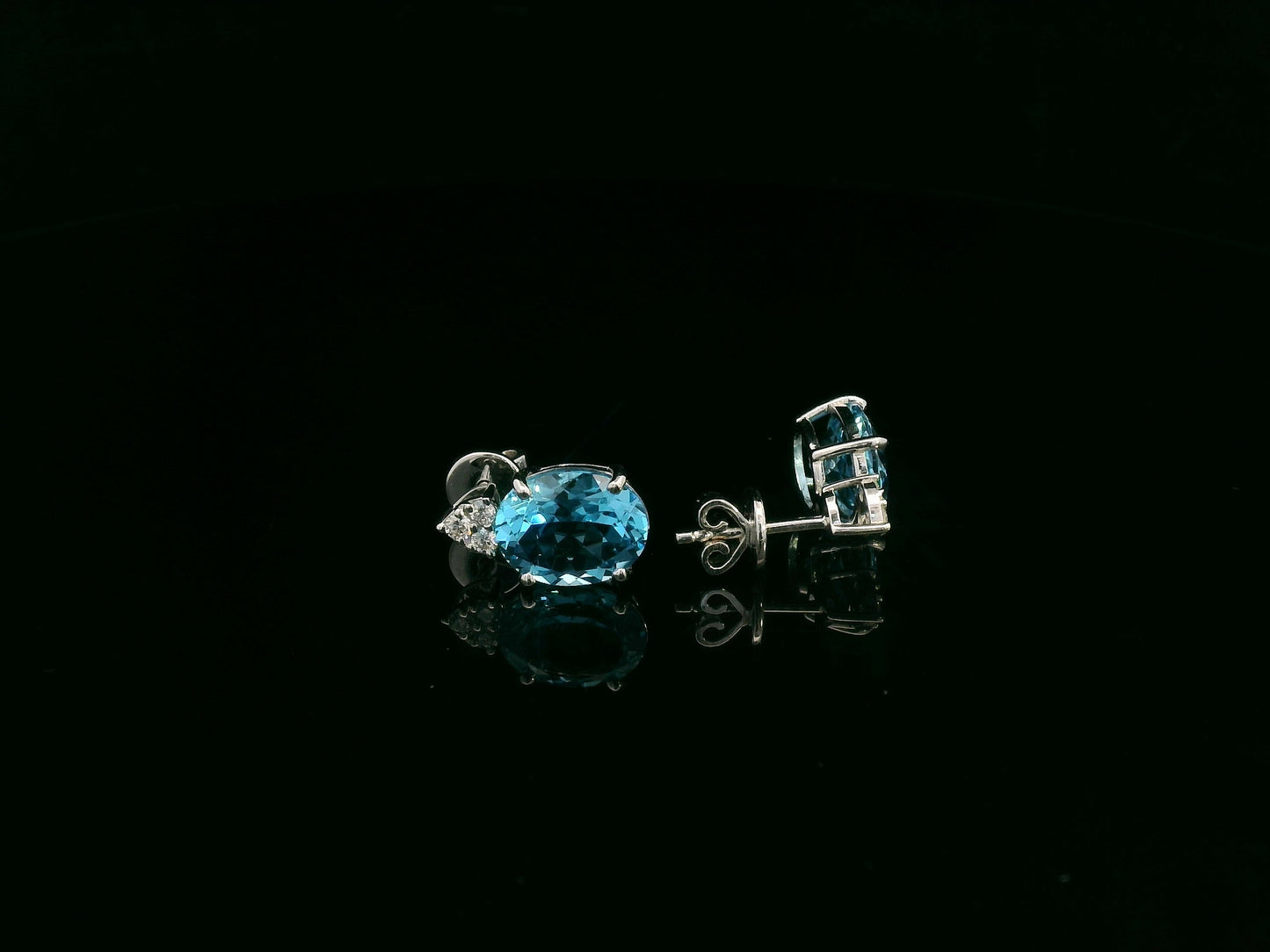 18K white gold stud earrings with oval Swiss Blue Topaz and  diamond accents