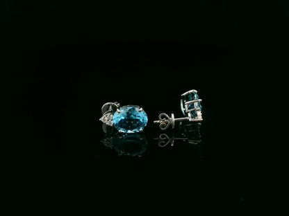 18K white gold stud earrings with oval Swiss Blue Topaz and  diamond accents