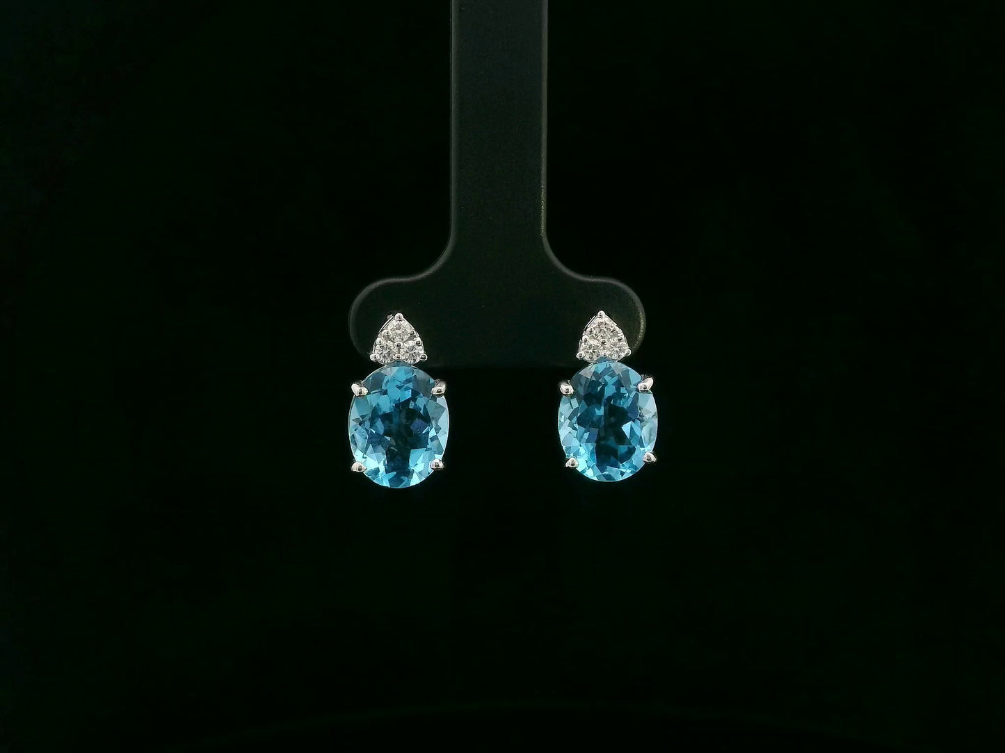 18K white gold stud earrings with oval Swiss Blue Topaz and  diamond accents