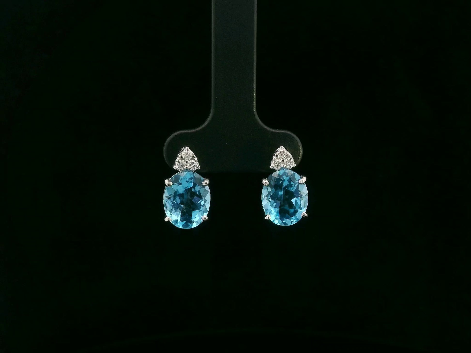 18K white gold stud earrings with oval Swiss Blue Topaz and  diamond accents