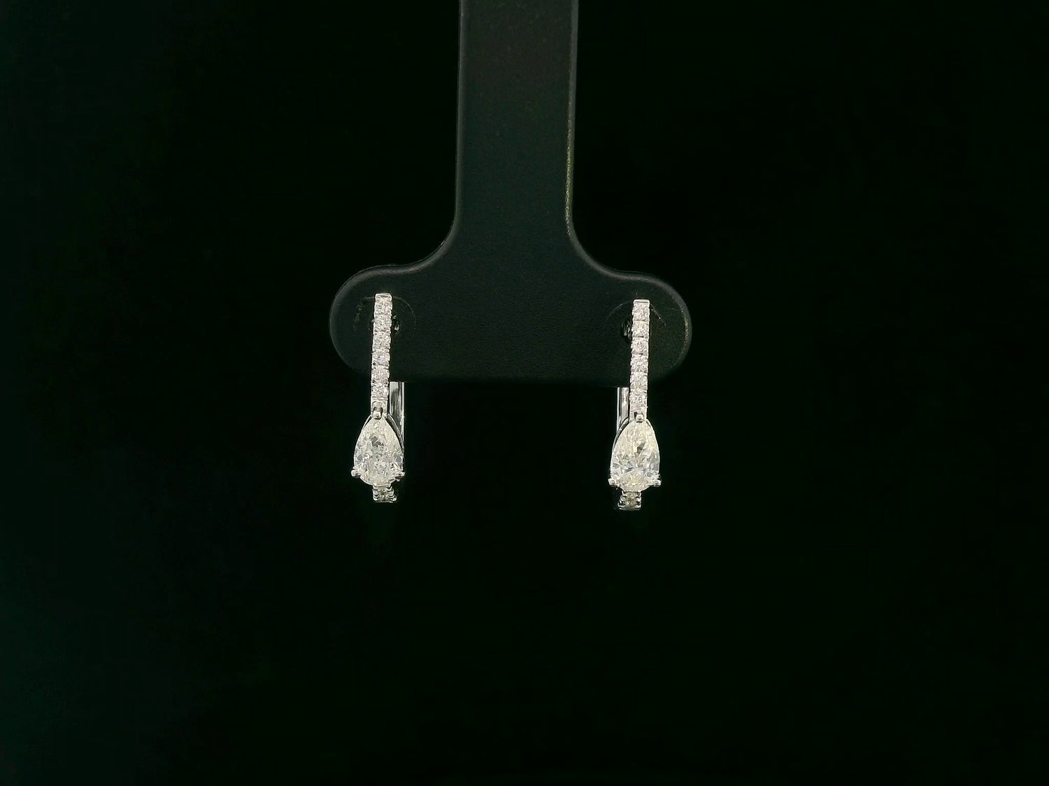 18K white gold pear diamond huggie earrings with center-set pear diamonds – Emirates Diamonds