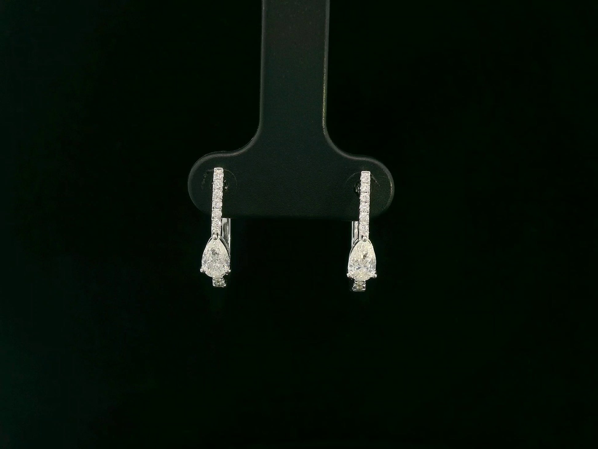18K white gold pear diamond huggie earrings with center-set pear diamonds – Emirates Diamonds